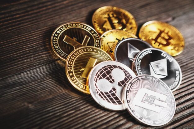 silver-and-golden-coins-with-bitcoin-ripple-and-ethereum-symbol-on-wood-1